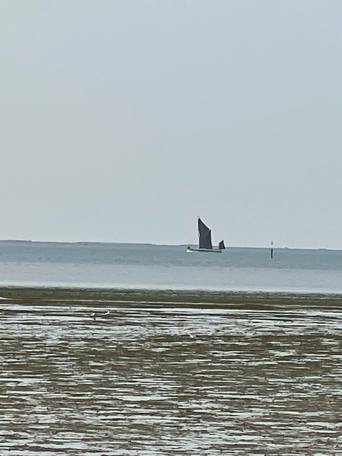 Small boat at low tide near Minster Leas