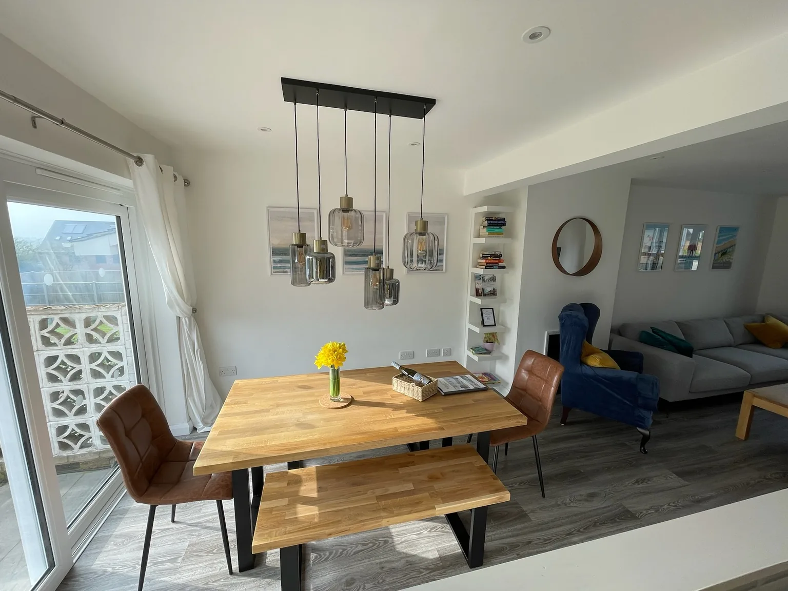 Dining table set for six beside the garden doors