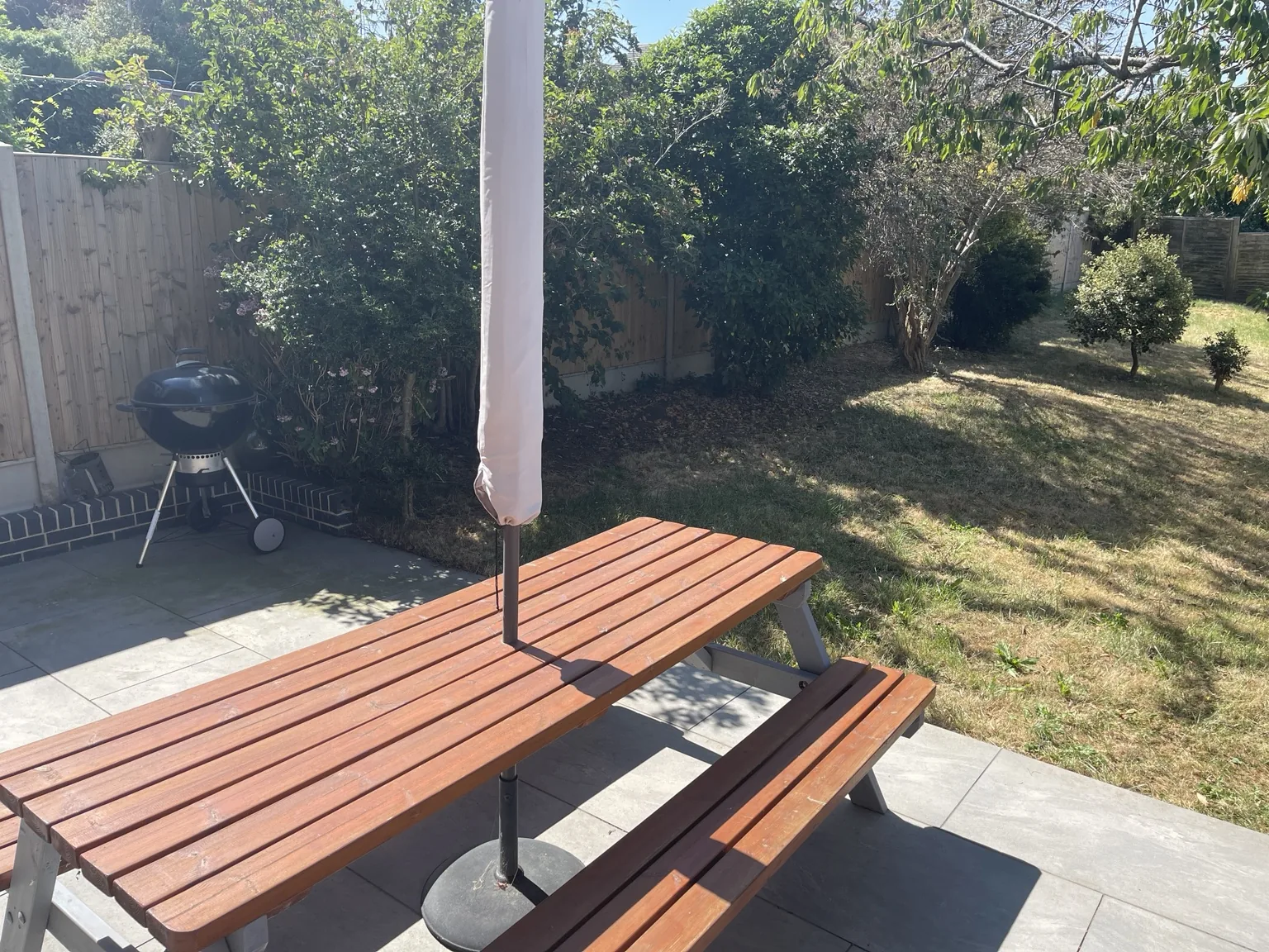 Charcoal barbecue beside the enclosed garden