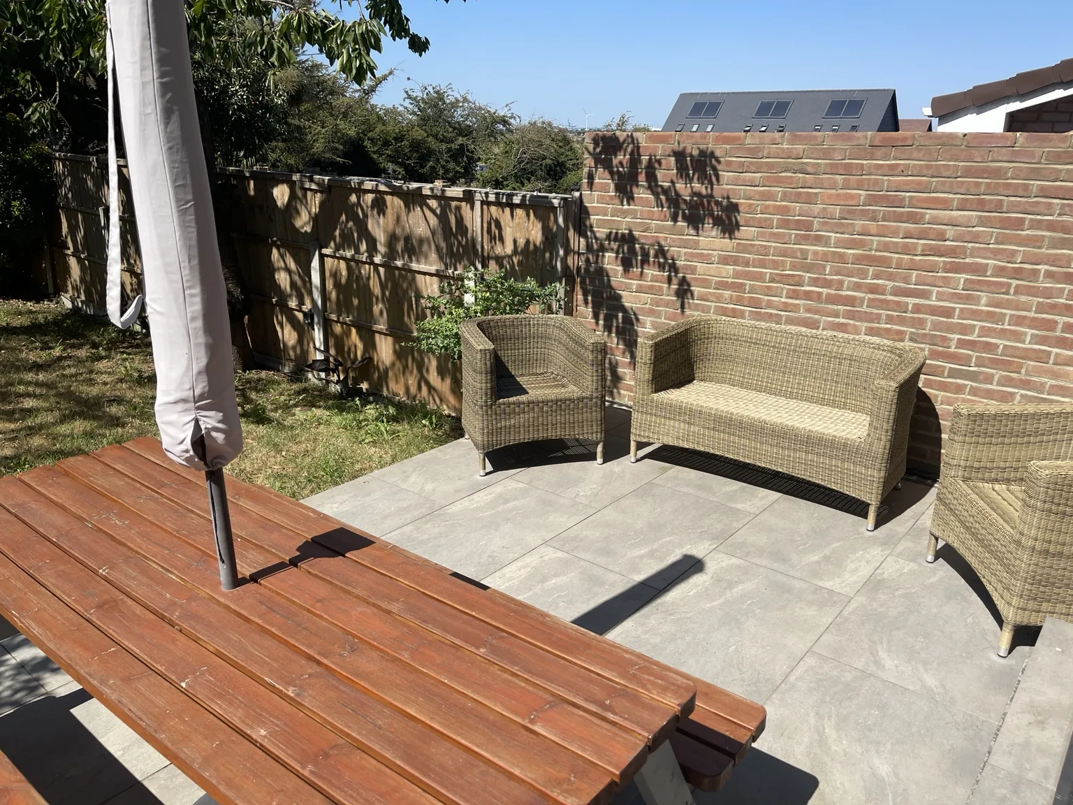 Patio seating and outdoor table beside the house