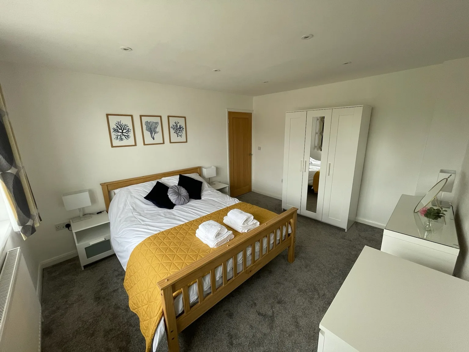 Alternative view of the king bedroom with yellow bedspread